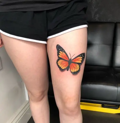 Black and Orange Butterfly Thigh Tattoo