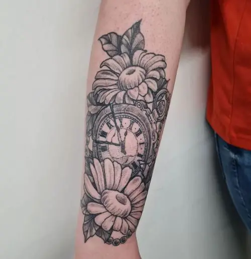 Clock Between Daisy Flowers Tattoo