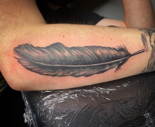 Deep Black Raven Feather Tattoo on Arm