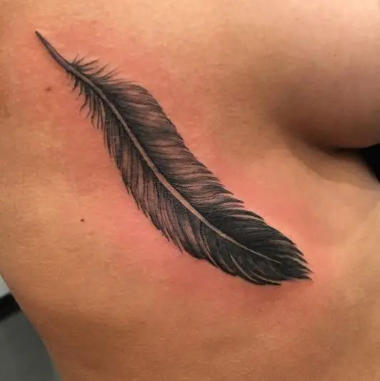 Eagle feather tattoo on ribs