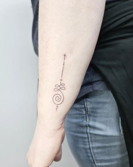 Fine line unalome tattoo with a small cross