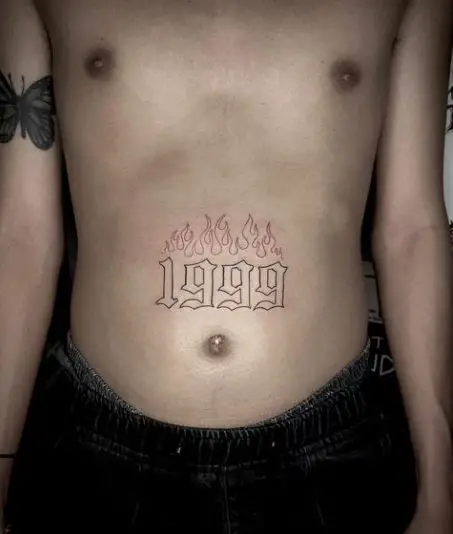 Flaming 1999 Tattoo On Tummy