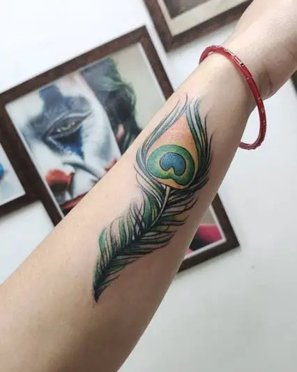 Green Peacock Feather Tattoo On Arm