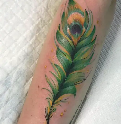 Green Water Colored Peacock Tattoo On Arm