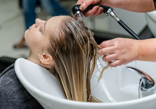 Hairdresser Washing Customer's Hair