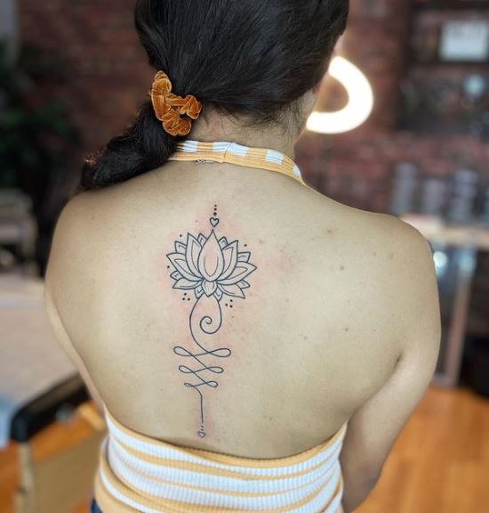 Small Heart and Lotus Flower Spine Tattoo