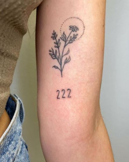 222 lettering tattoo located on the rib done in red