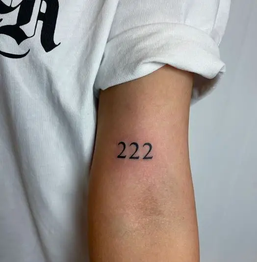 Bold 222 Tattoo on the Upper Elbow