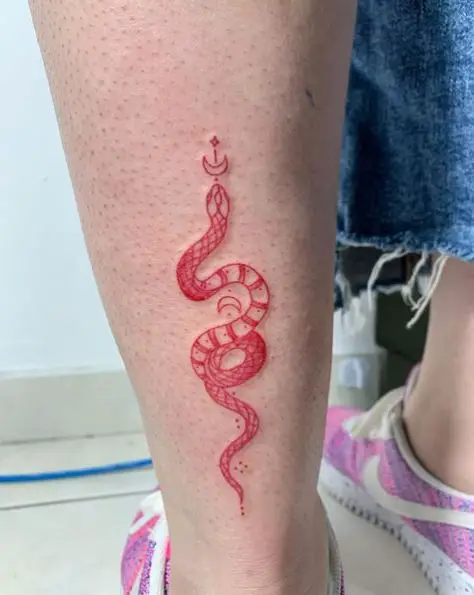 Red snake tattoo on the calf