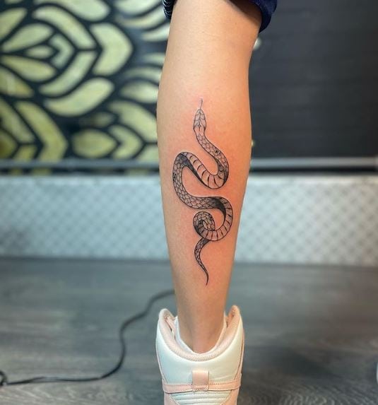 Black snake tattoo on calf