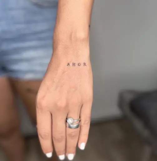 Tiny AMOR Text Tattoo