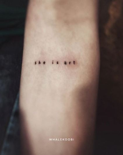 Tiny SHE IS ART Typewriter Tattoo