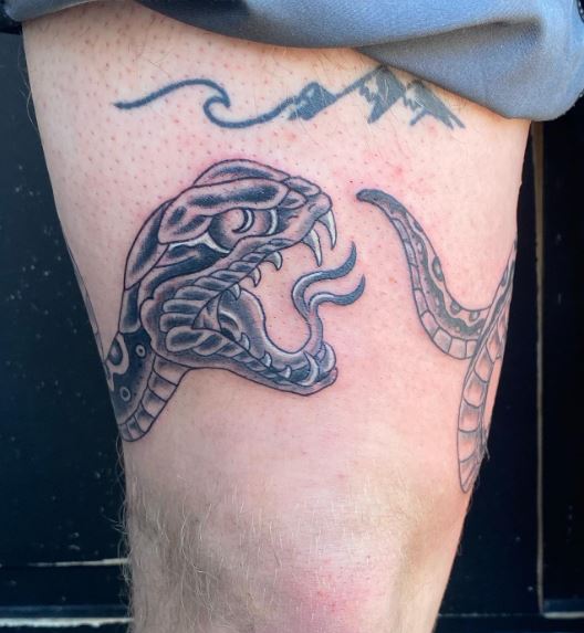 scary snake tattoo on thigh