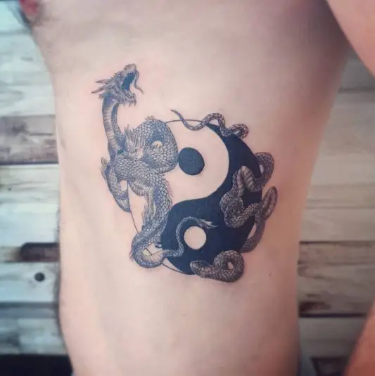 Yin and yang symbol with dragon and snake tattoo