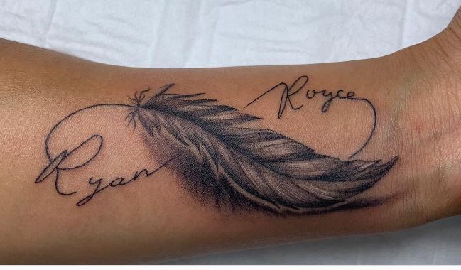 artistic infinity sign tattoo with feather and names