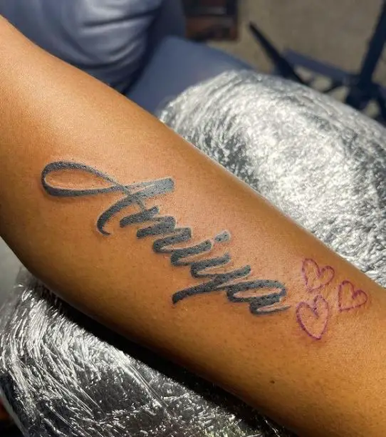 bold name tattoo with hearts