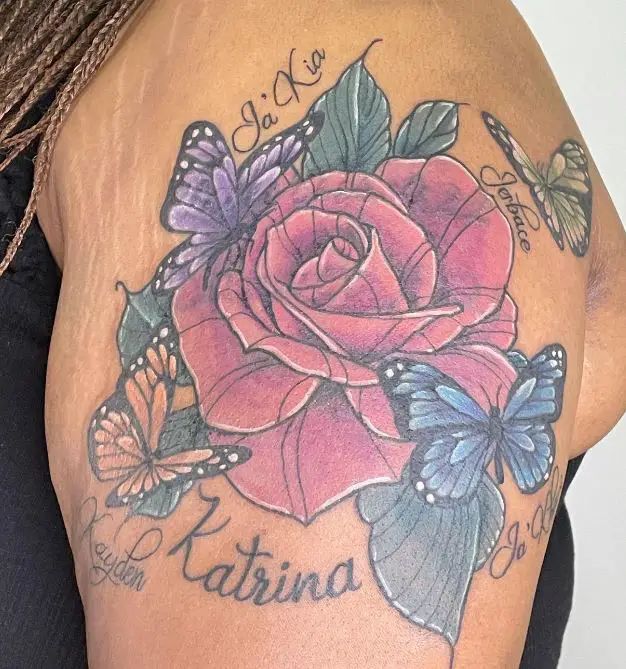 large rose tattoo with butterflies and names