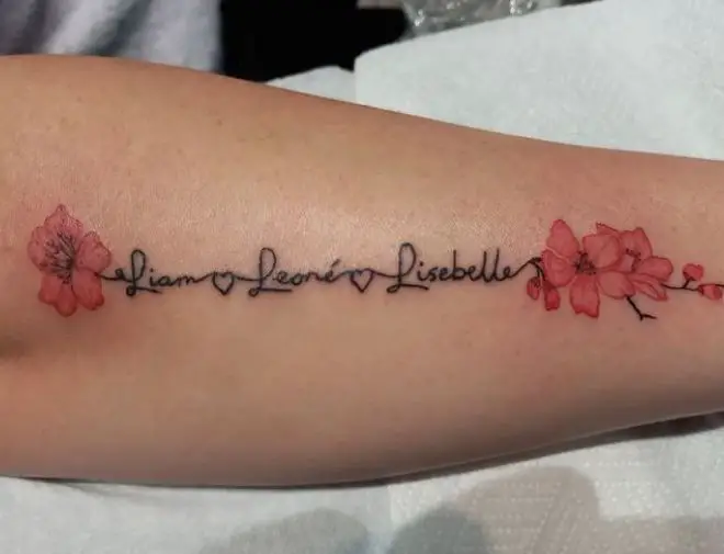 pretty cherry blossoms and names tattoo