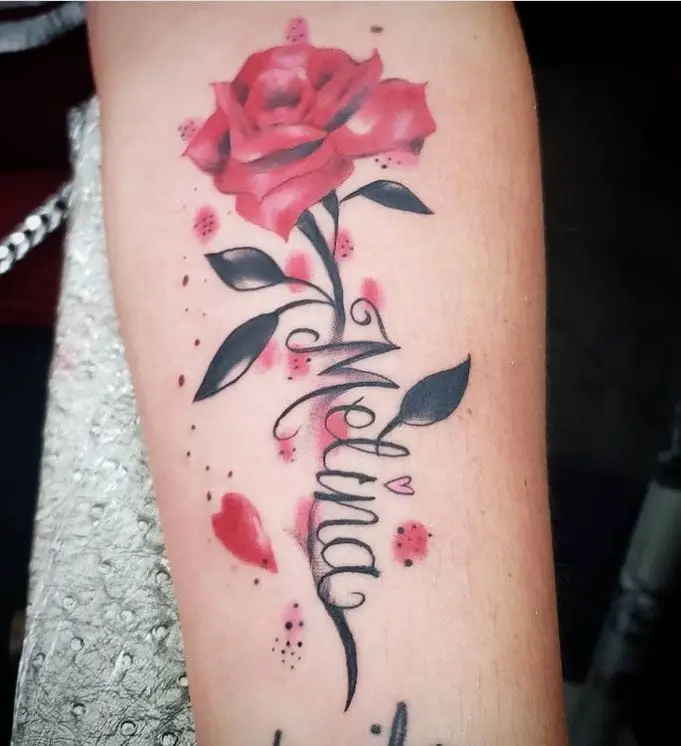 rose and name coloured tattoo