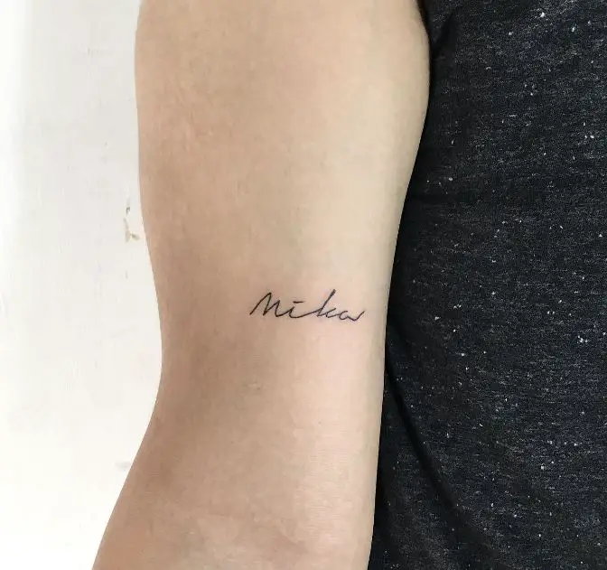 small kids name tattoo on the arm