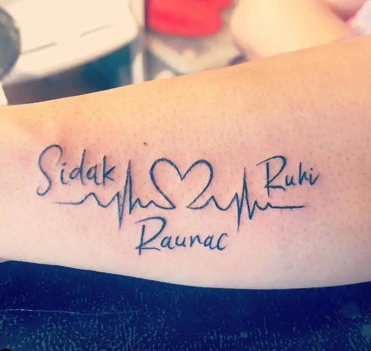 tattoo with 3 names and a heart beat