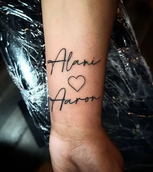 two kids names with a heart tattoo
