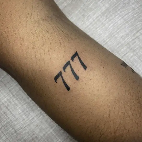 Black Minimalistic 777 Tattoo
