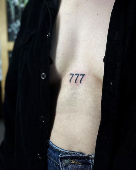 Minimalistic 777 between Breasts Tattoo