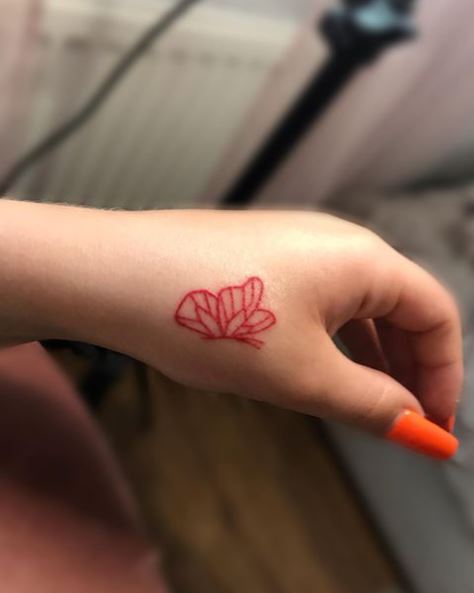 Small Red Butterfly Thumb Tattoo