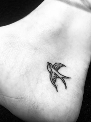 Minimalistic Black Swallow Heel Tattoo