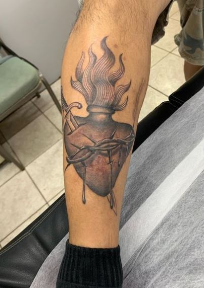 Sword thru Bleeding Sacred Heart Leg Tattoo