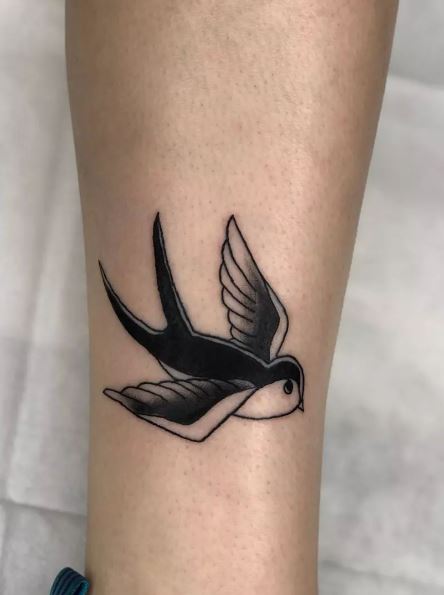 Flying Black Swallow Tattoo above Ankle