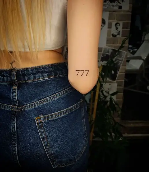 Grey Minimalistic 777 Elbow Tattoo
