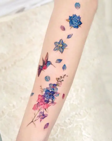 Colorful Hummingbird and Lilies Tattoo