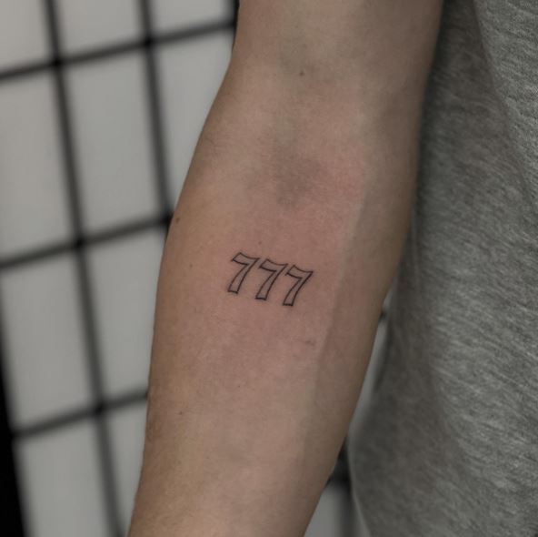 Fine-Line Minimalistic 777 Forearm Tattoo