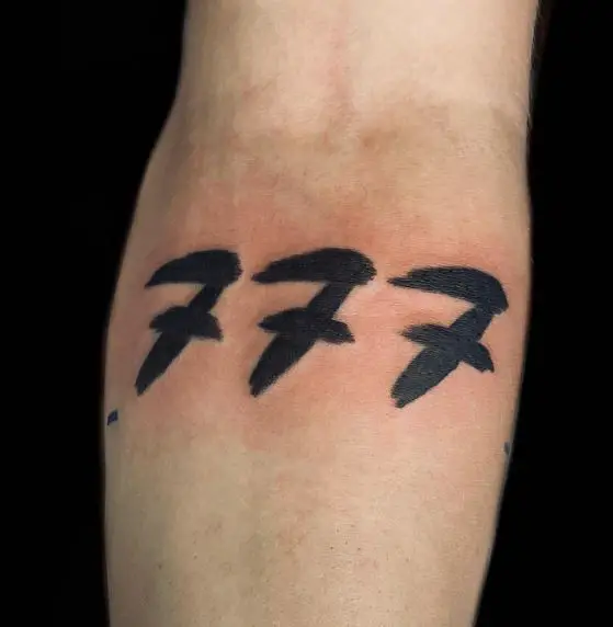 Black Lucky 777 Forearm Tattoo