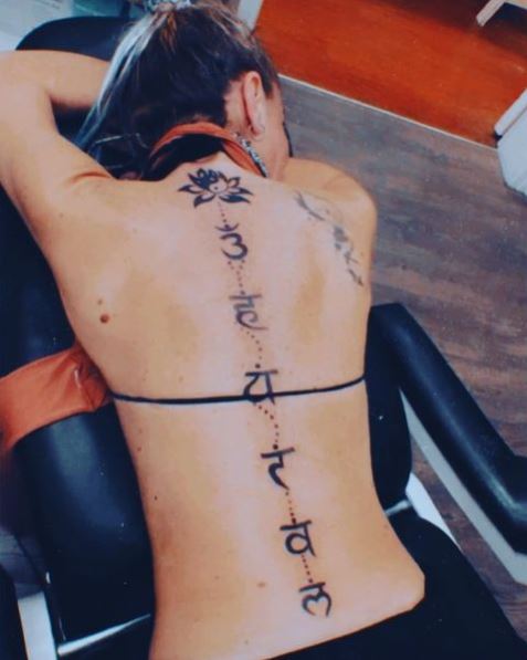 Chakra Symbols and Lotus Flower Spine Tattoo