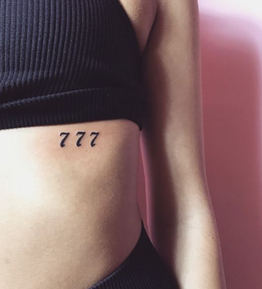 Black Minimalistic 777 Ribs Tattoo
