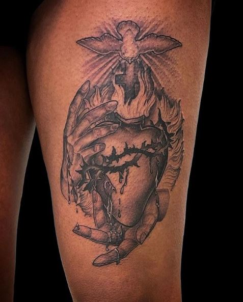 Hands Holding Bleeding Sacred Heart Thigh Tattoo