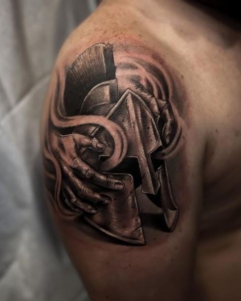 Grey Hands Holding Spartan Helmet Shoulder Tattoo