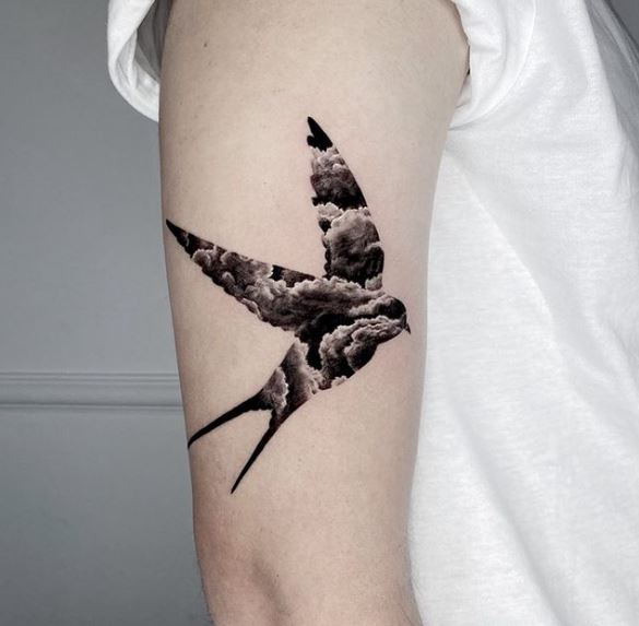 Cloud Patterned Swallow Biceps Tattoo