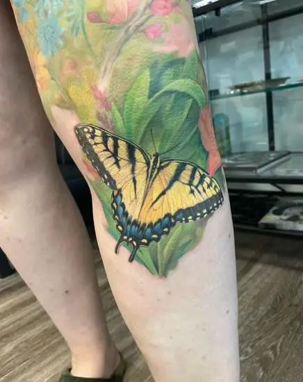 Floral Background and Yellow Butterfly Leg Tattoo