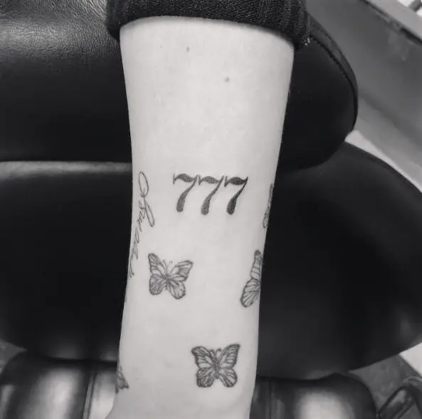 Grey Butterflies and 777 Arm Tattoo
