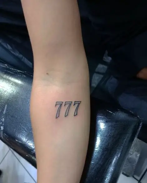 Grey 777 Forearm Tattoo