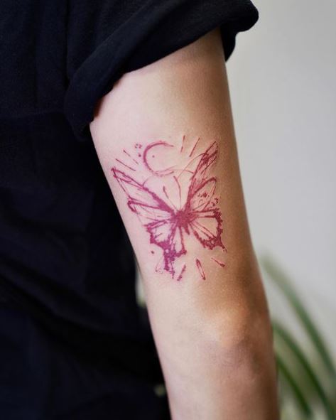 Red Butterfly above Elbow Tattoo