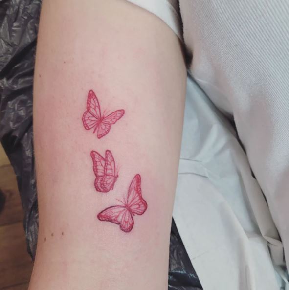 Three Small Red Butterflies Biceps Tattoo