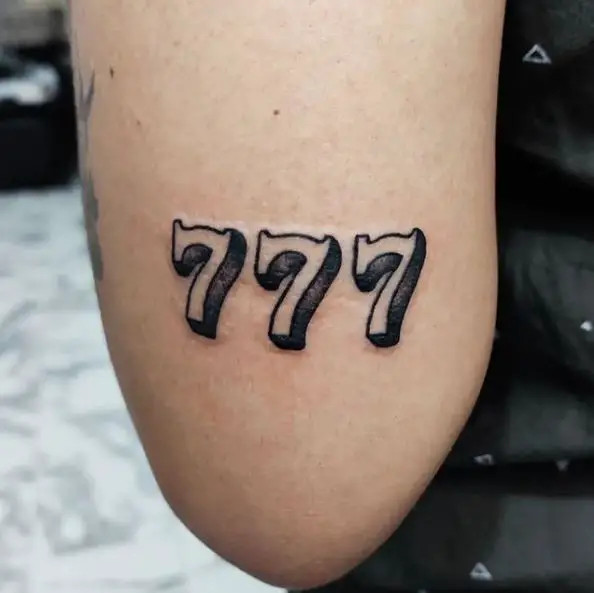 Black and White 777 Elbow Tattoo