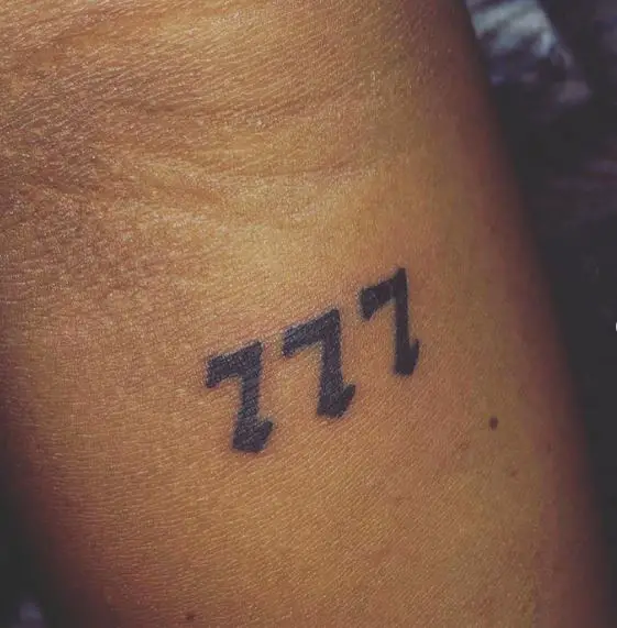 Grey Minimalistic 777 Forearm Tattoo
