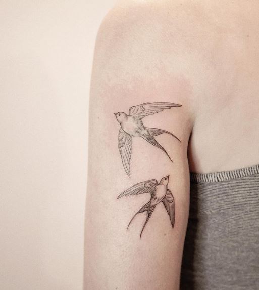 Grey Flying Two Swallows Biceps Tattoo