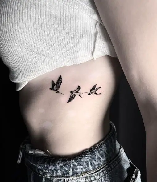 Black and White Family of Three Swallows Ribs Tattoo